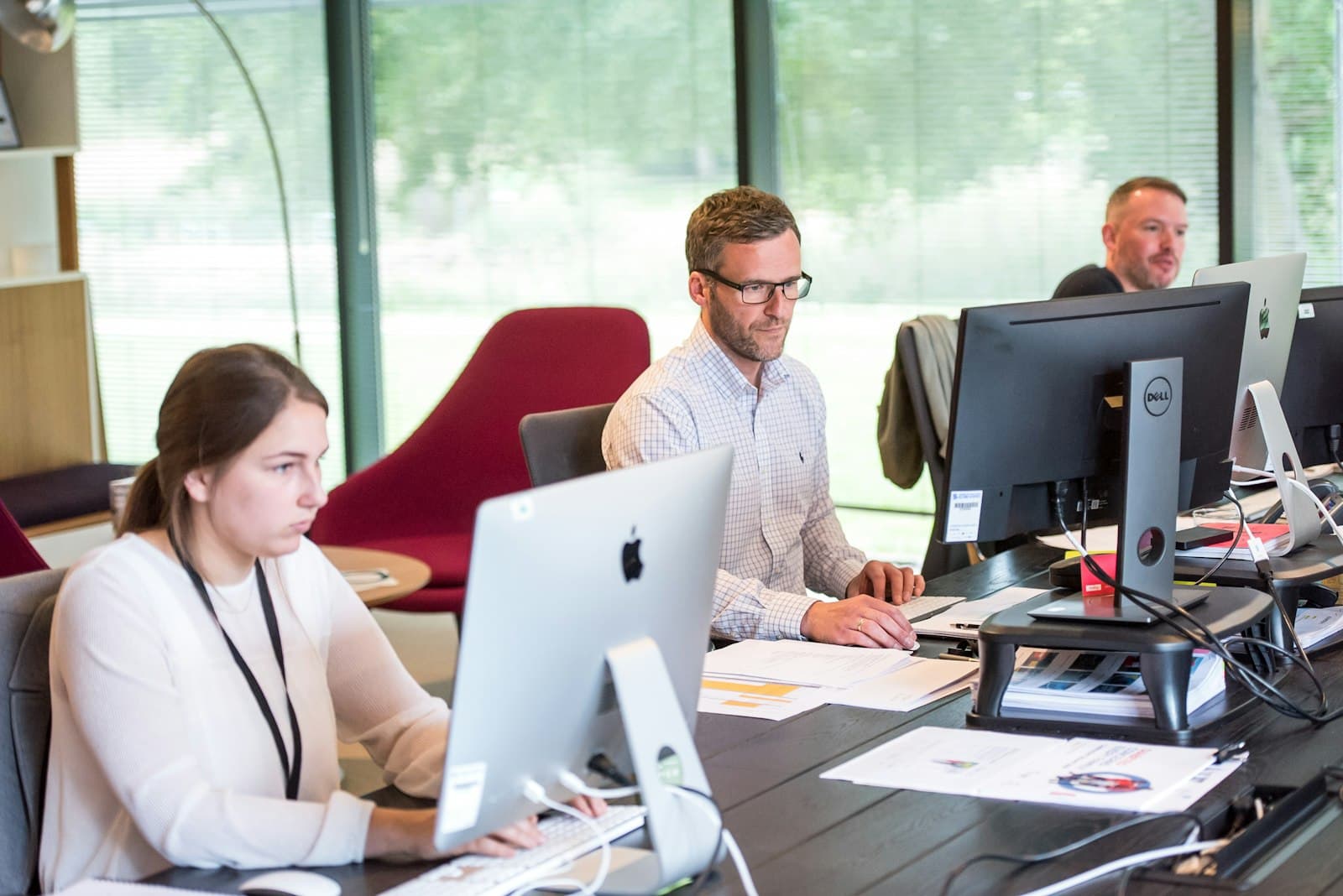 Team working at computers in a bright office