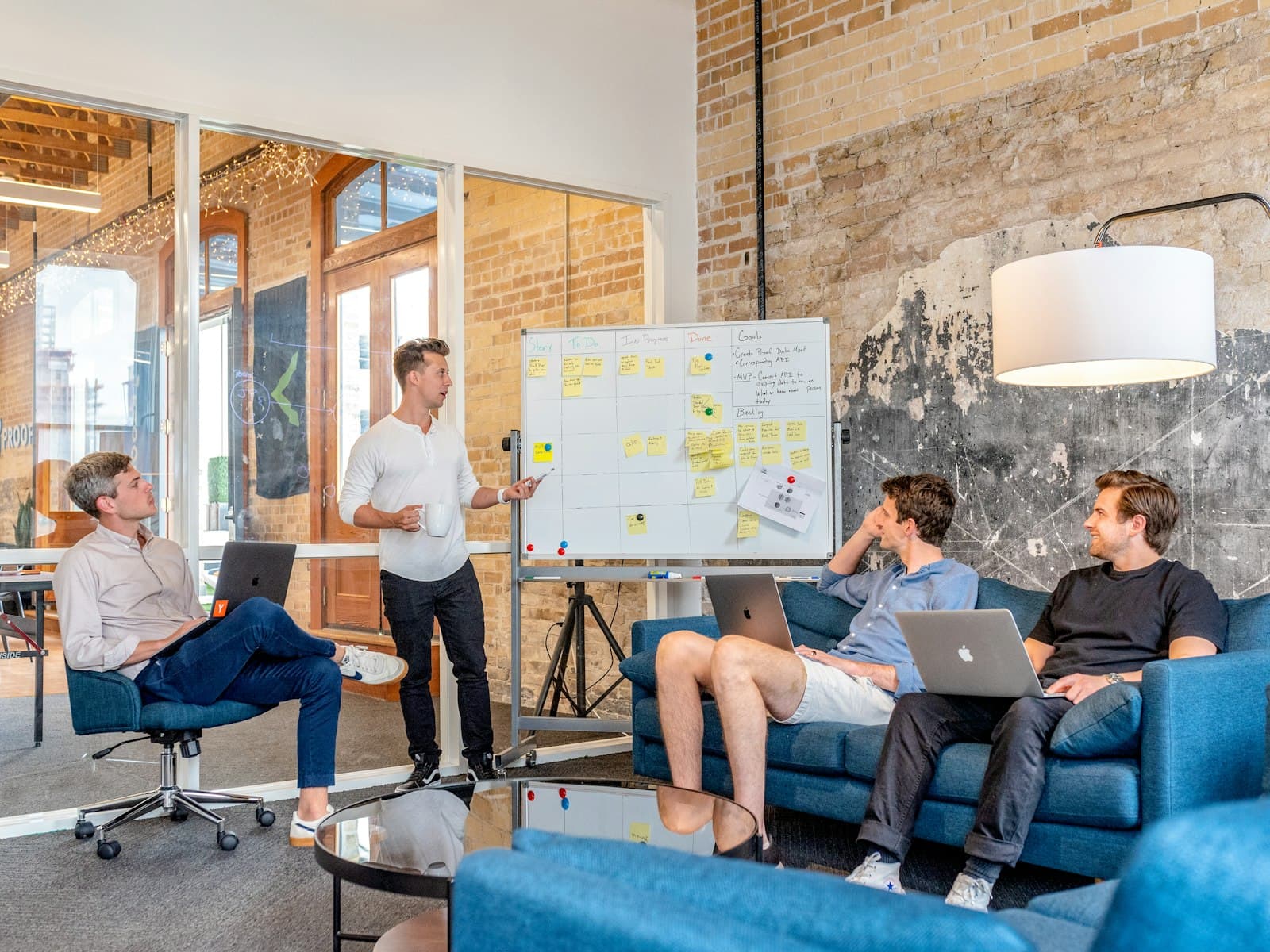 Team discussing a plan in front of a whiteboard