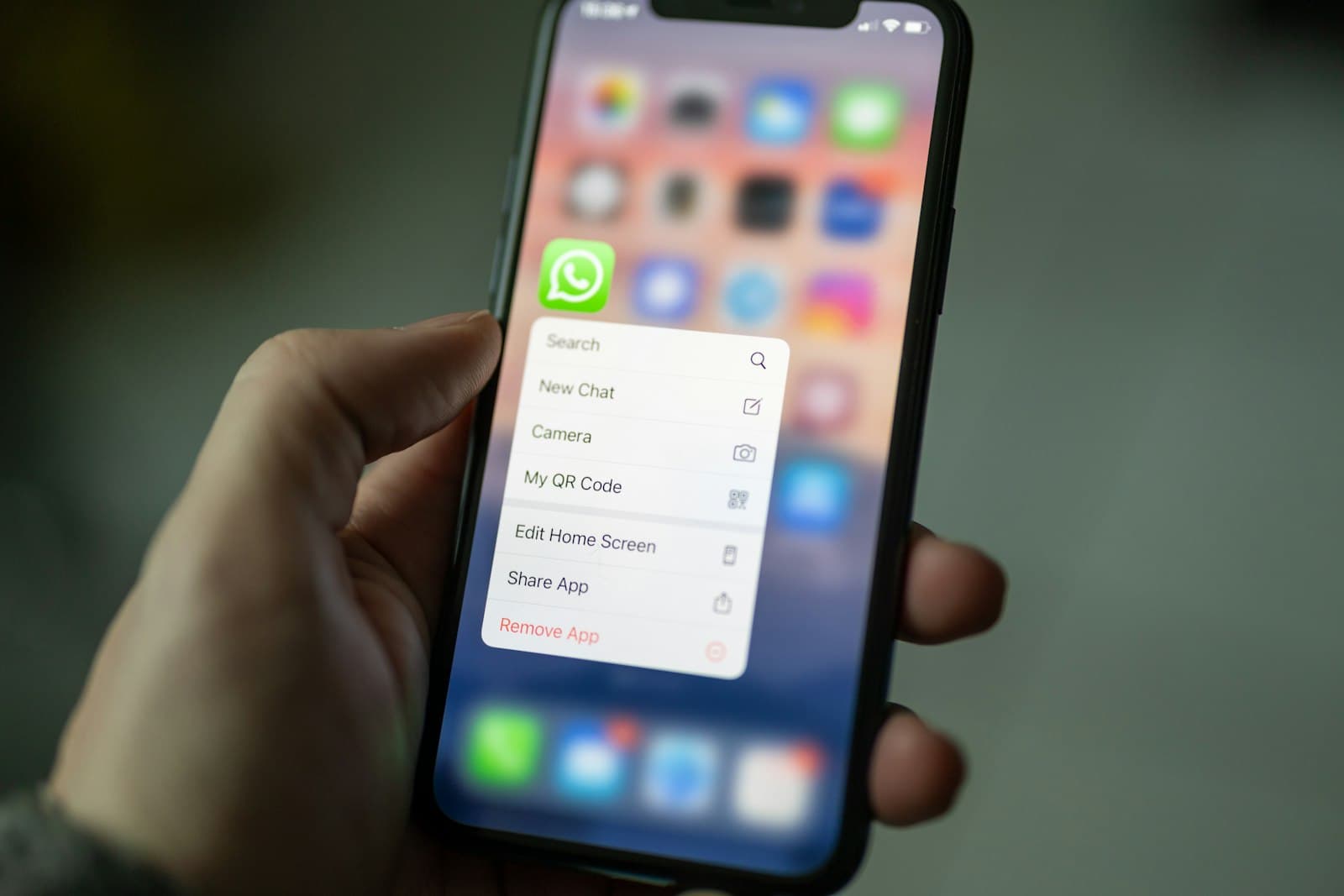 Person holding a smartphone with messaging apps